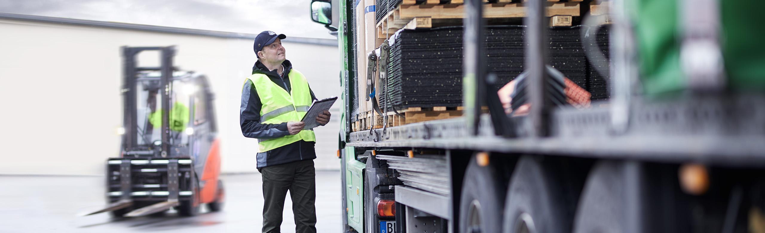 friction matting, high friction rubber, rubber friction mats, anti friction mat, cargo friction mats, load securement friction mats worker in front of cargo with fork lift